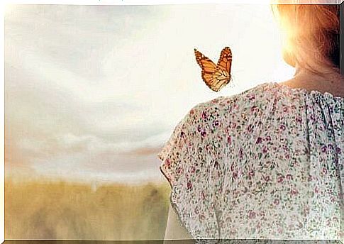 Butterfly landing on a woman's shoulder.