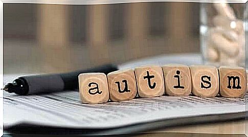 Blocks on paper spell the word "autism"