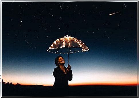 A woman with an umbrella with candles