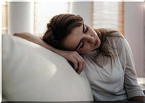 Woman resting on sofa.