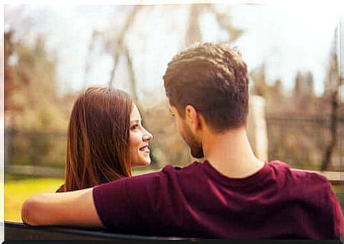 Man and woman sitting on park bench.