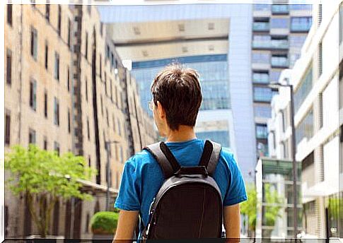 Man with backpack walking in a city