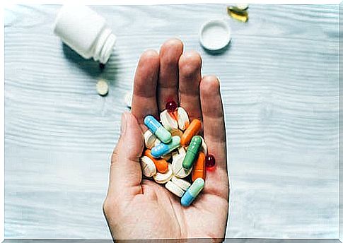 A hand with a lot of pills