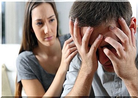 woman comforts a man in pain